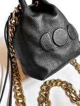 Load image into Gallery viewer, black leather bag with gold chain and embossed logo design