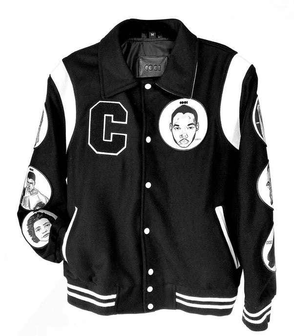 Black and white varsity jacket with chenille letter patch and patches with drawings on them