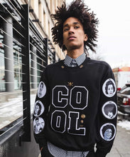 Load image into Gallery viewer, Black crewneck sweatshirt with chenille letter patches on the front and patches with black icons on the sleeves