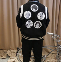 Load image into Gallery viewer, Black and white varsity jacket with chenille letter patch and patches with drawings on them men