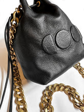 Load image into Gallery viewer, black leather bag with gold chain and embossed logo design

