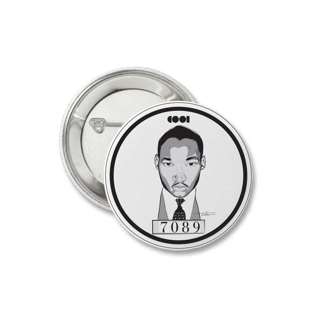 White and black matte pin back button with MLK drawing on it