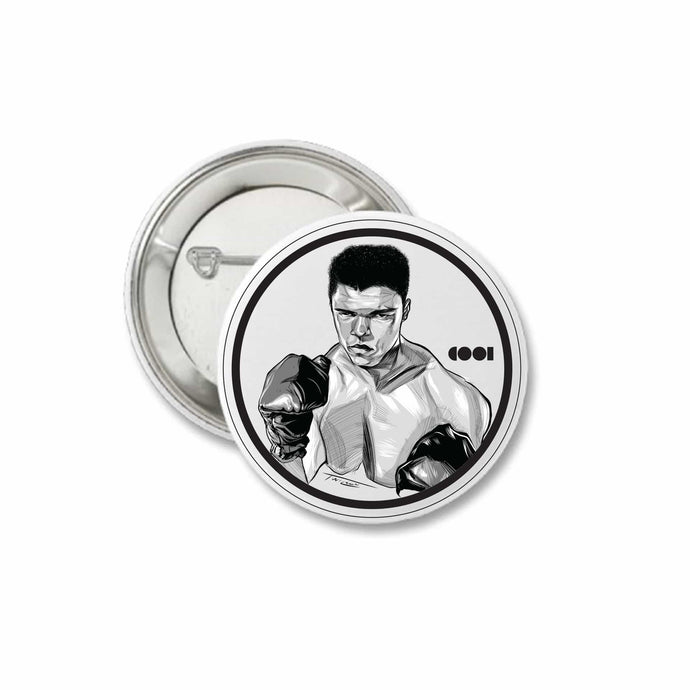 White and black matte pin back button with Muhammed Ali drawing on it