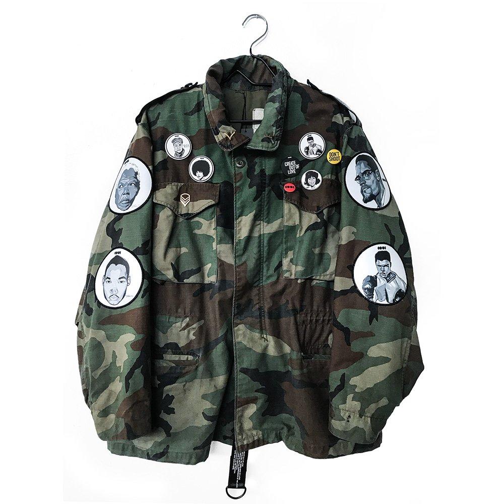Woodland Camo jacket with pins and patches on the sleeves