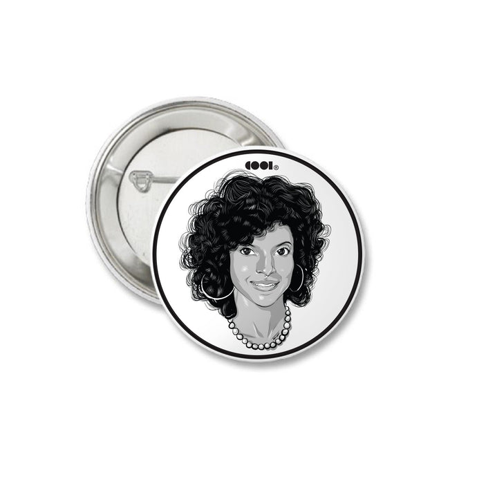 White and black matte pin back button with Clair Huxtable drawing on it